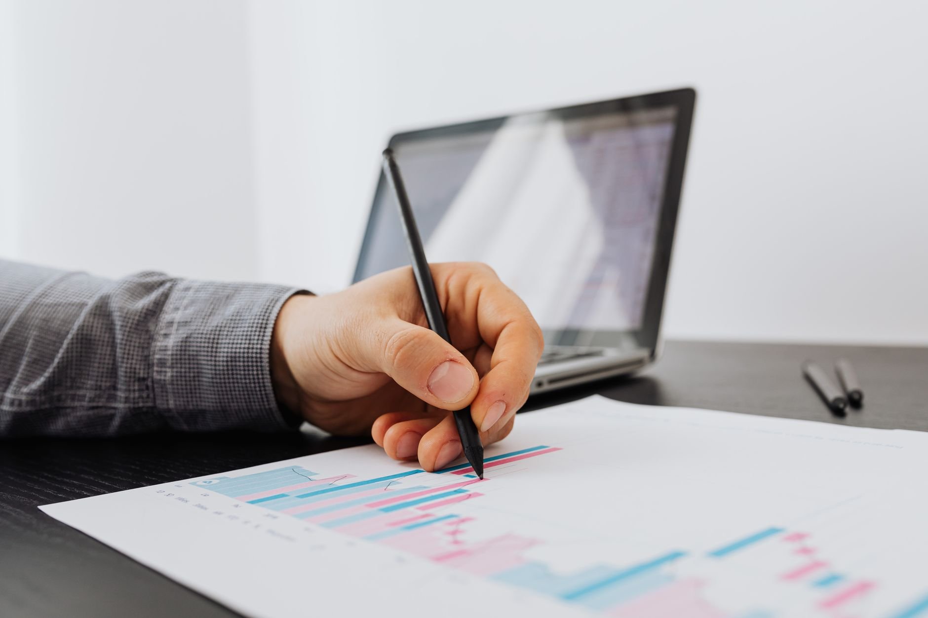 Person reviewing business growth charts with a laptop